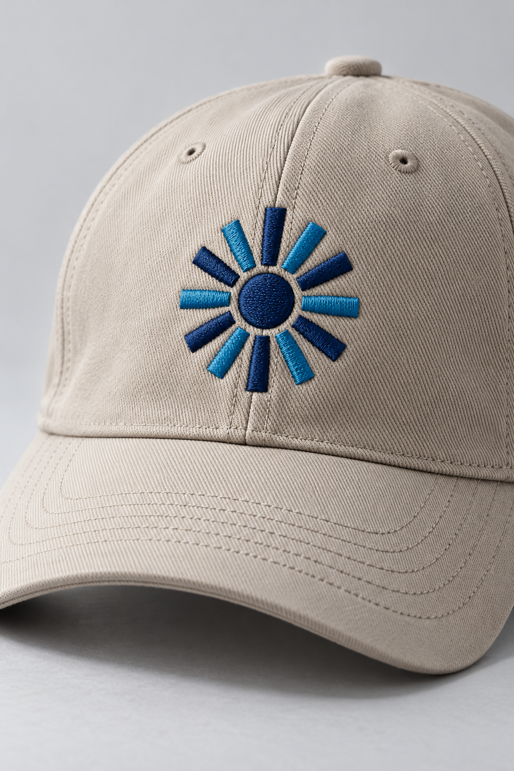 Stone twill cap with a blue embroidered sunburst